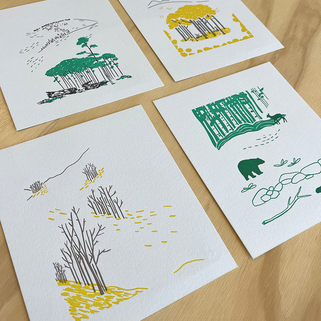 Forest scene printed in green with trees in the background and a deer, bear, and beaver